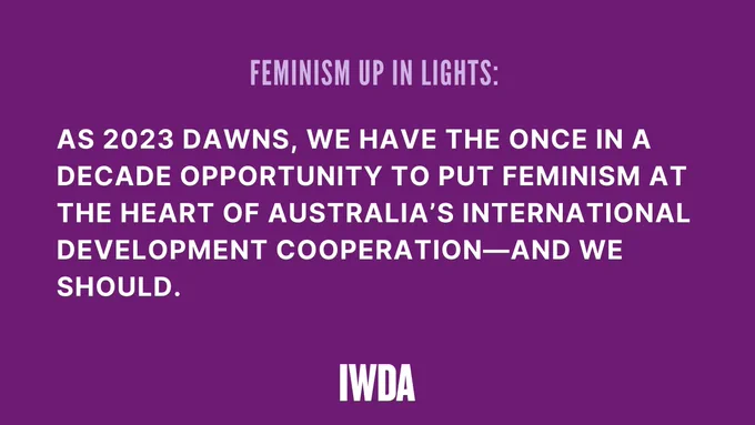 Large white text says "As 2023 dawns, we have the once in a decade opportunity to put feminism at the heart of Australia's international development cooperation - and we should." The background is purple and there's more text about the article. Logo - IWDA.