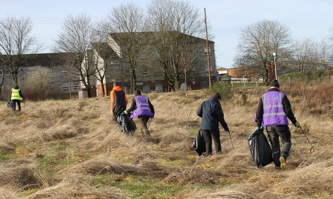 volunteers doing a litter pick at Blairtummock Park, Easterhouse.