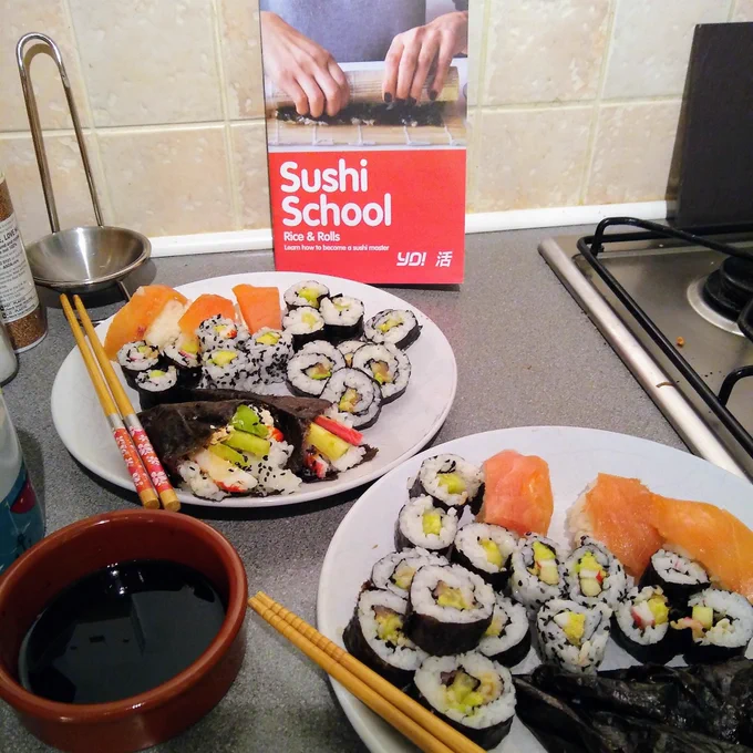 A meal of homemade sushi, with the Yo Sushi instruction book in the background 