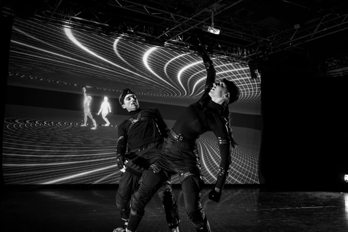 Two artists perform using motion capture technology