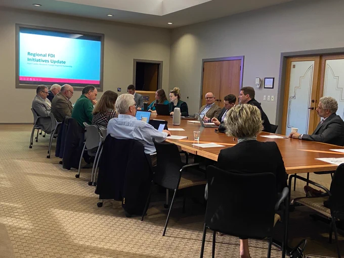 A group of people sitting around a conference table