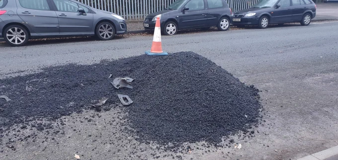 A large pile of tarmac that had been dumped in the middle of the road