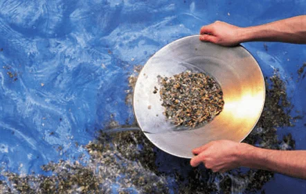 Someone panning for gold in a river 