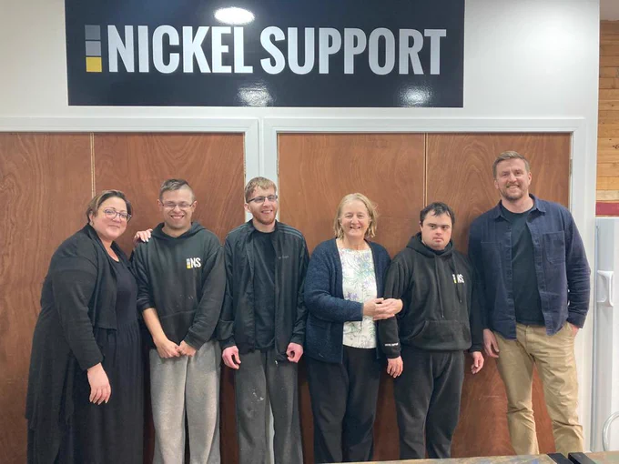 The Leader of Sutton Council, Councillor Ruth Dombey, standing with trainees and staff from Nickel Support