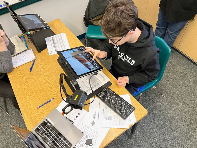 Student in a classroom working on a low vision device MagniLink Tab, by @MagniLink