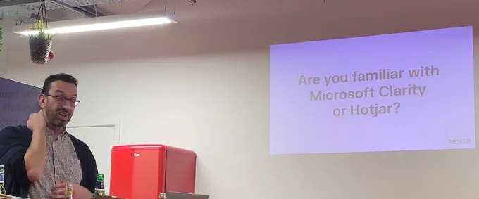 Andrew Rickards showing os Clarity talk. The slide says "Are you familiar with Microsoft Clarity or Hot Jar 