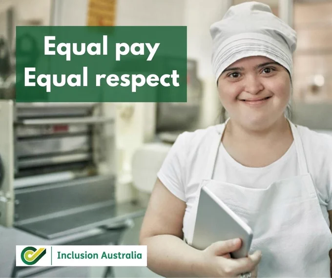 A young woman smiling in chef overalls and a sign saying Equal Pay Equal Respect