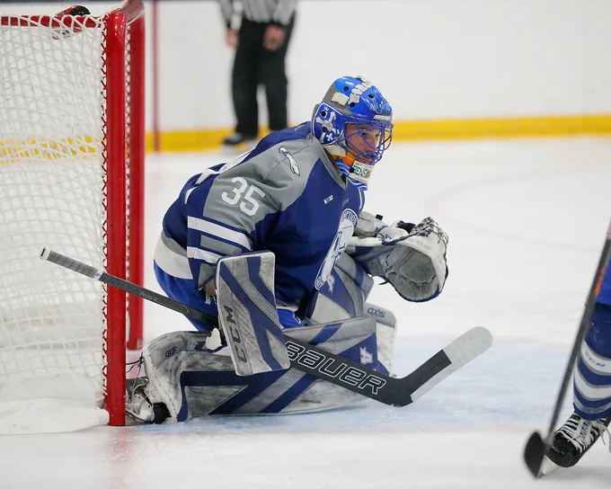 Assumption University's Drew Benedict (Graduate Student, G #35) waits to block an opponent's shot. 