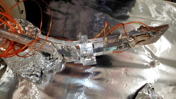 A metal frame, with various small parts fixed to it (the targets for the GBAR positrons), looking awfully bent...
