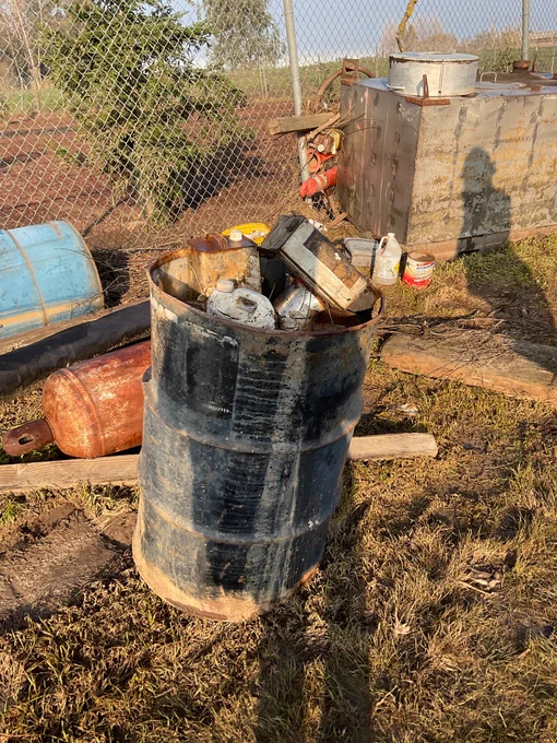 Image of emptied 55-gallon barrel and other miscellaneous containers of hazardous waste DTSC hazmat crews mitigated on a parcel of land in Merced County this week. 