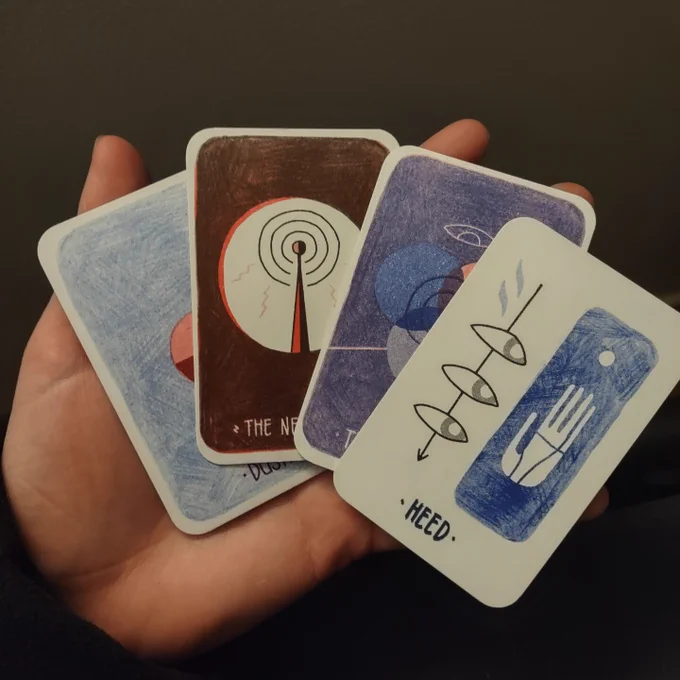 A hand holding a sample of 4 cards from the Braided Oracle deck: "Dusk," "The Network," "The Mirror," and "Heed".