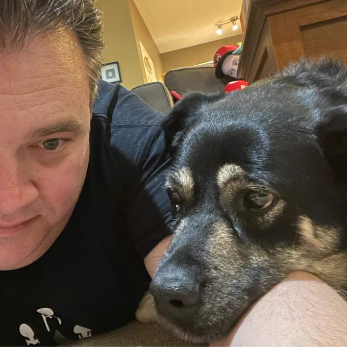 dog with her head on her humans arm. 