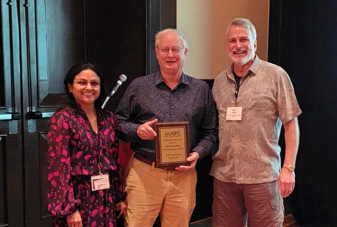 Ray accepted the award plaque at AMSPC 2023, Puerto Vallarta, Medico Bina Joe (AMSPC President), Ray Dingledine, Kent Vrana (Past President)
