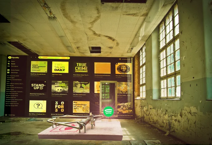 A scary abandoned room. The back wall is stained with the Spotify podcast selection screen. In the center of the room is an oversized mousetrap, baited with the Spotify logo.