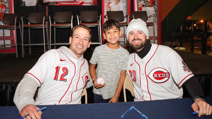 Spencer Steer and Nick Northcut pose with a fan.