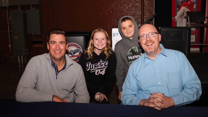 Tommy Thrall and John Sadak pose with a pair of young fans.