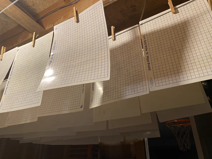 Dry erase boards hanging on a laundry line.
