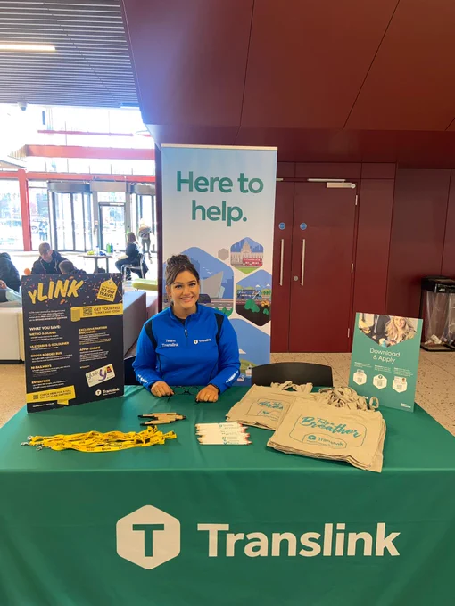 Team Translink behind a desk at Queens Students Union