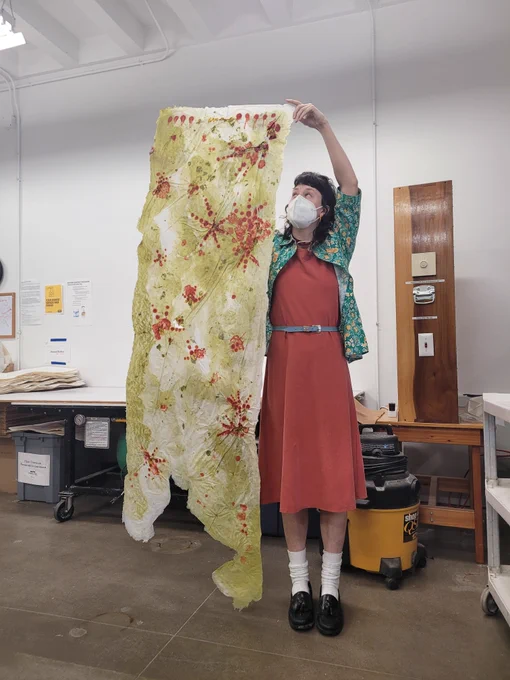 Olivia with a giant piece of paper she made at the University of Iowa Center for the Book.