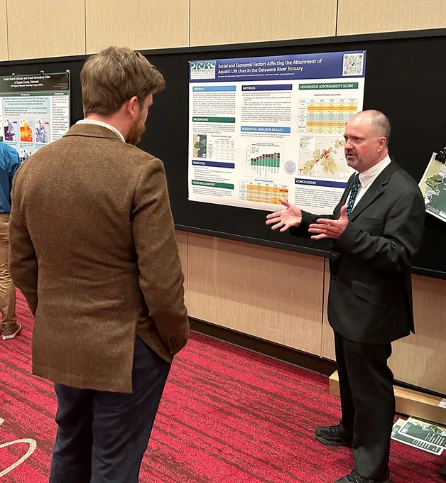DRBC Manager of Water Quality Assessment John Yagecic, P.E., talks with a Summit attendee about our examination of socio-economic factors affecting improved dissolved oxygen in the Delaware River Estuary. Photo by the DRBC.