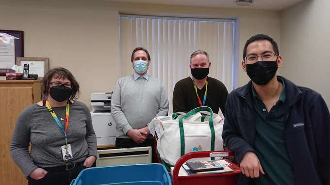 Haliburton County Public Librarians and members of Mugo Web meeting at HCPL. Picture is of 4 masked individuals. 