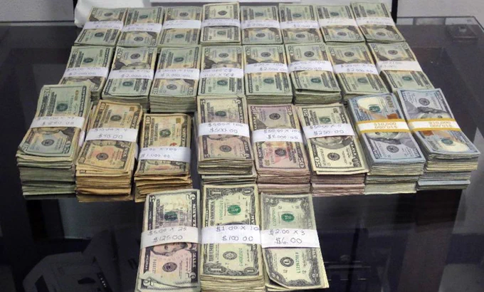 27 bundles of U.S. currency with the first bill being either a $1, $5, and $20 bill on top
