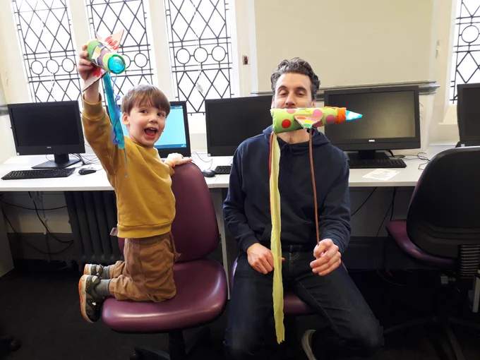 Boy and dad holding the Rockets they made