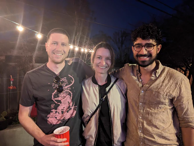 Three people smiling