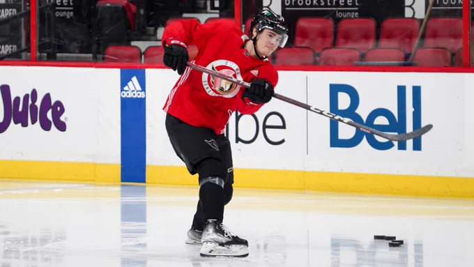 Ridly Greig puts a shot on net before the start of practice this morning at Canadian Tire Centre