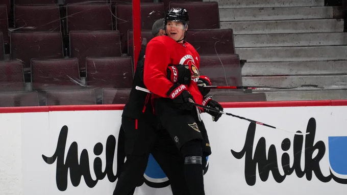 Tim Stützle celebrates with a member of the coaching staff after scoring a tough goal during a drill at this morning's practice at Canadian Tire Centre