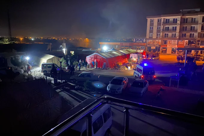 13 February 2023, southern Turkey. Members of the UK Emergency Medical Team construct a tented field clinic next to a hospital that was damaged in the Turkey earthquake.
