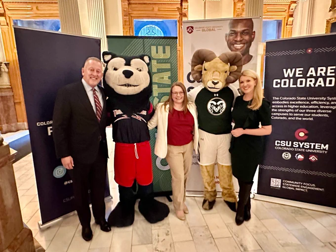 Tim Mottet, Pamela Tooney, Amy Parsons pose for photo with CSU Pueblo's ThunderWolves mascot and CSU Fort Collins' CAM the Ram mascot. 