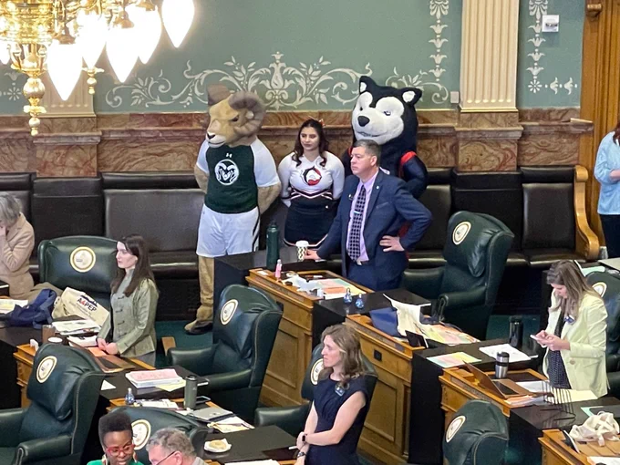 CAM the Ram mascot, ThunderWolves mascot and member of CSU Pueblo cheer team observe proceedings on legislative floor at the Colorado State Capitol. 