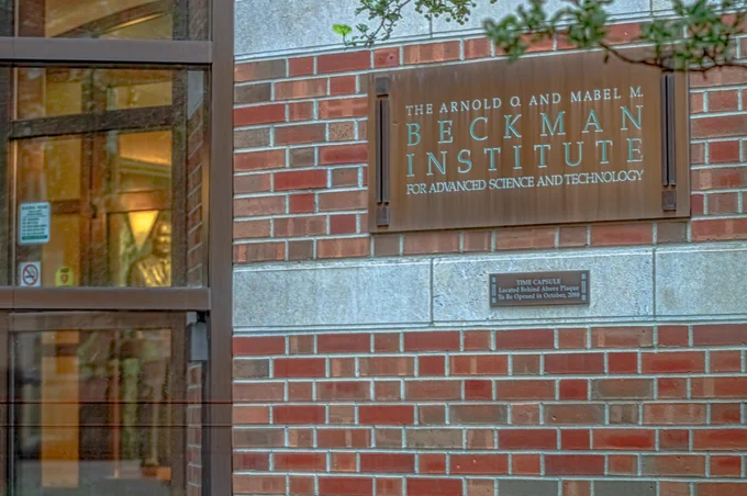 Beckman's south-facing entrance bears a sign that reads: "The Arnold O. and Mabel M. Beckman Institute for Advanced Science and Technology."