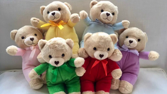 Six TLC teddy bears lined up