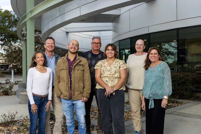 NysnoBio team members outside their lab in Alachua, Florida posing for a group photo.