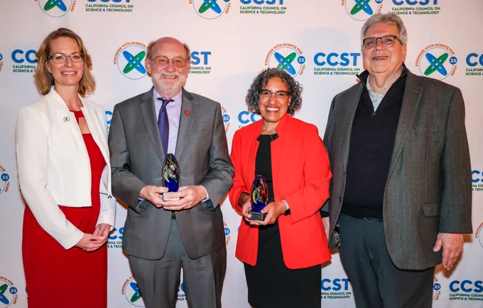 CCST leadership standing with Liane Randolph and John Laird in front of a CCST logo step and repeat.