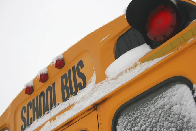 Rear view of a school bus with snow