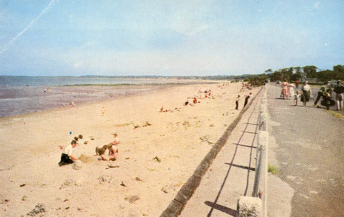 Old colour photograph of beach with promenade