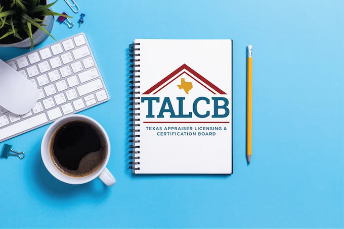 A coffee mug, keyboard and mouse, and notebook with the TALCB logo are on a blue background