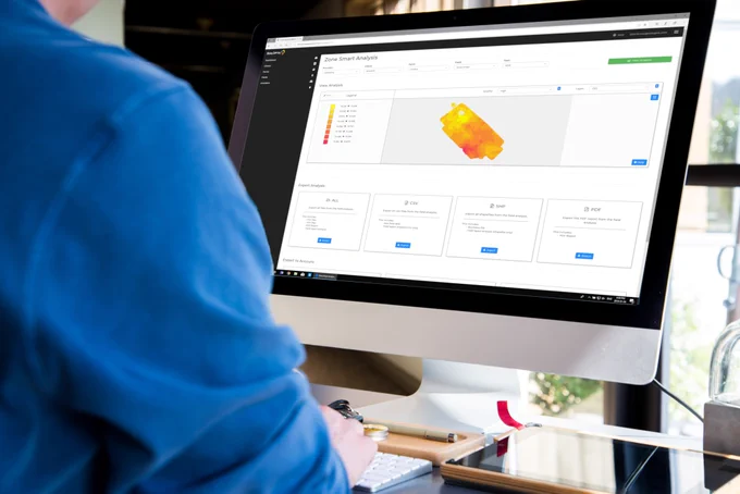 Staff member working on a computer displaying a customer portal