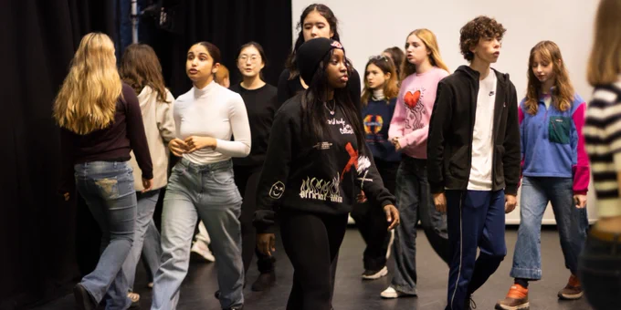 A group of Musical Theatre Junior Academy students walking around. 