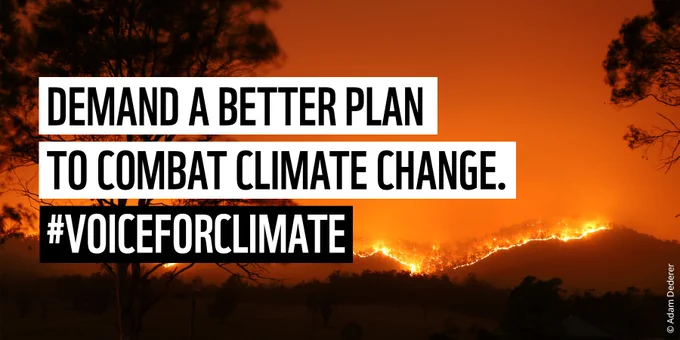 Image of a forest fire burning in the distance, turning the sky orange behind silhouetted trees. Text reads 'Demand a better plan to combat climate change. #VoiceForClimate'