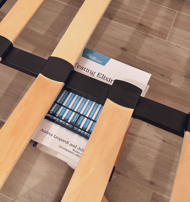 The bed frame being kind of held in place by copies of "Testing Elixir", the book I co-wrote with Jeffrey