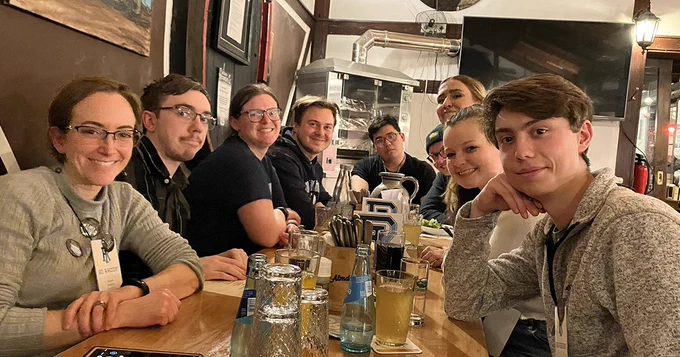 A table of URI alumni at a meetup in Europe.
