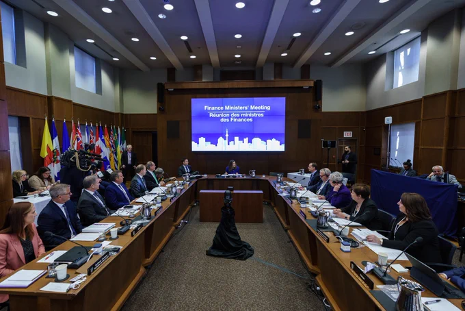 The Deputy Prime Minister, seated, attending the provincial and territorial Finance Ministers’ Meeting.