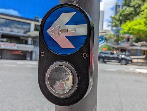 The PB/5 crosswalk button, featuring a circle you press below a large tactile silver arrow