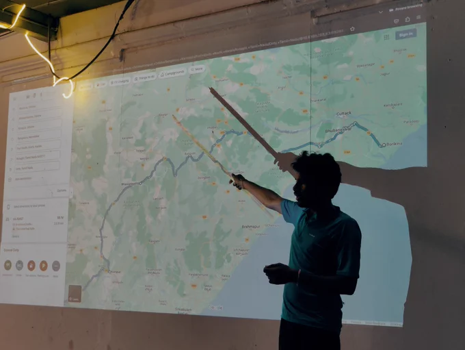 Man pointing to a map of India. 