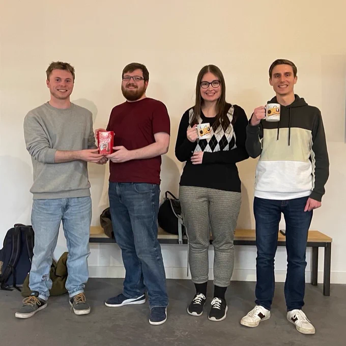 The 4 Bristol based Global Game Jam winners pose with their prize mugs and chocolate.