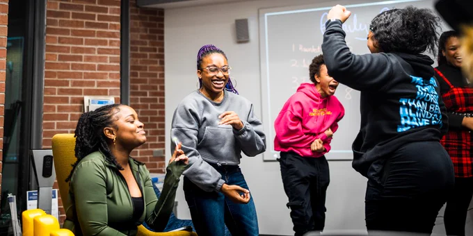A group of students laughing and celebrating.